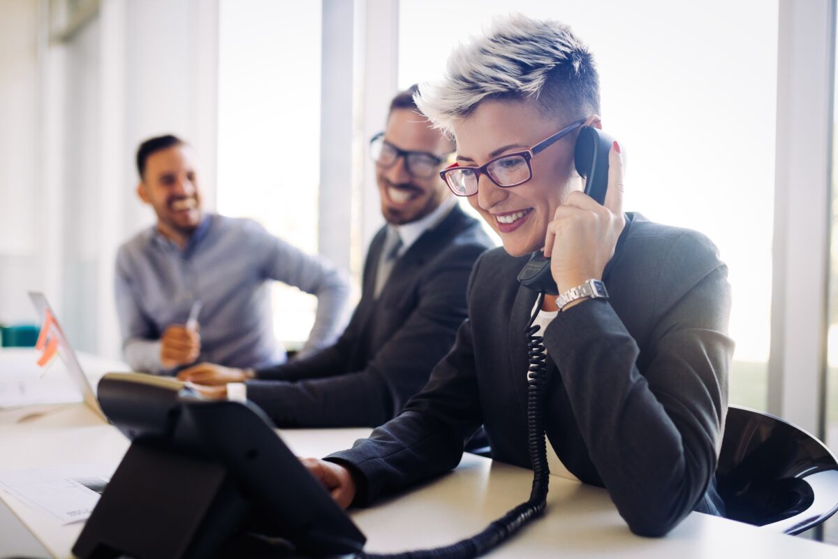 Portrait of busy female architect talking on phone