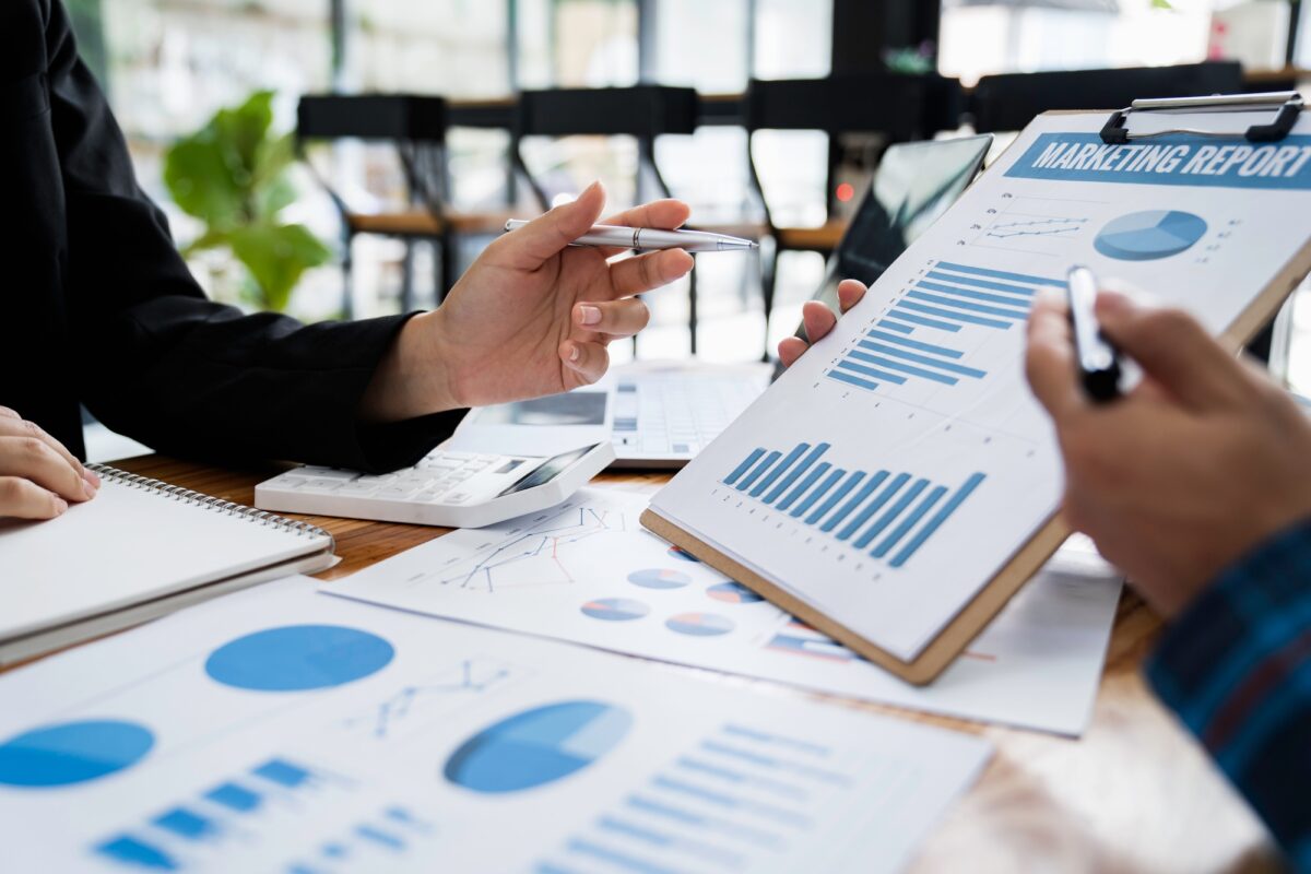 Business Asian people are meeting to analyze data figures to plan business strategy with financial p