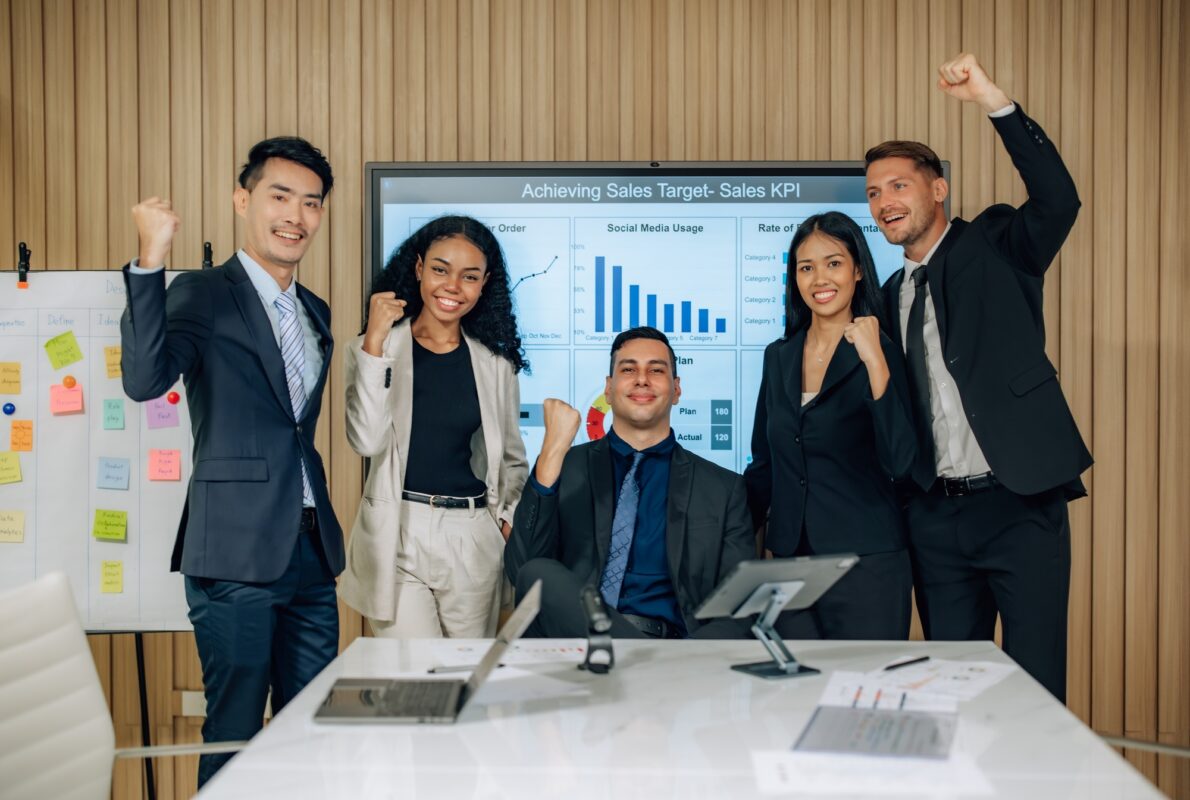 Diverse team innovates for sales KPIs via collaborative brainstorming to develop business models.
