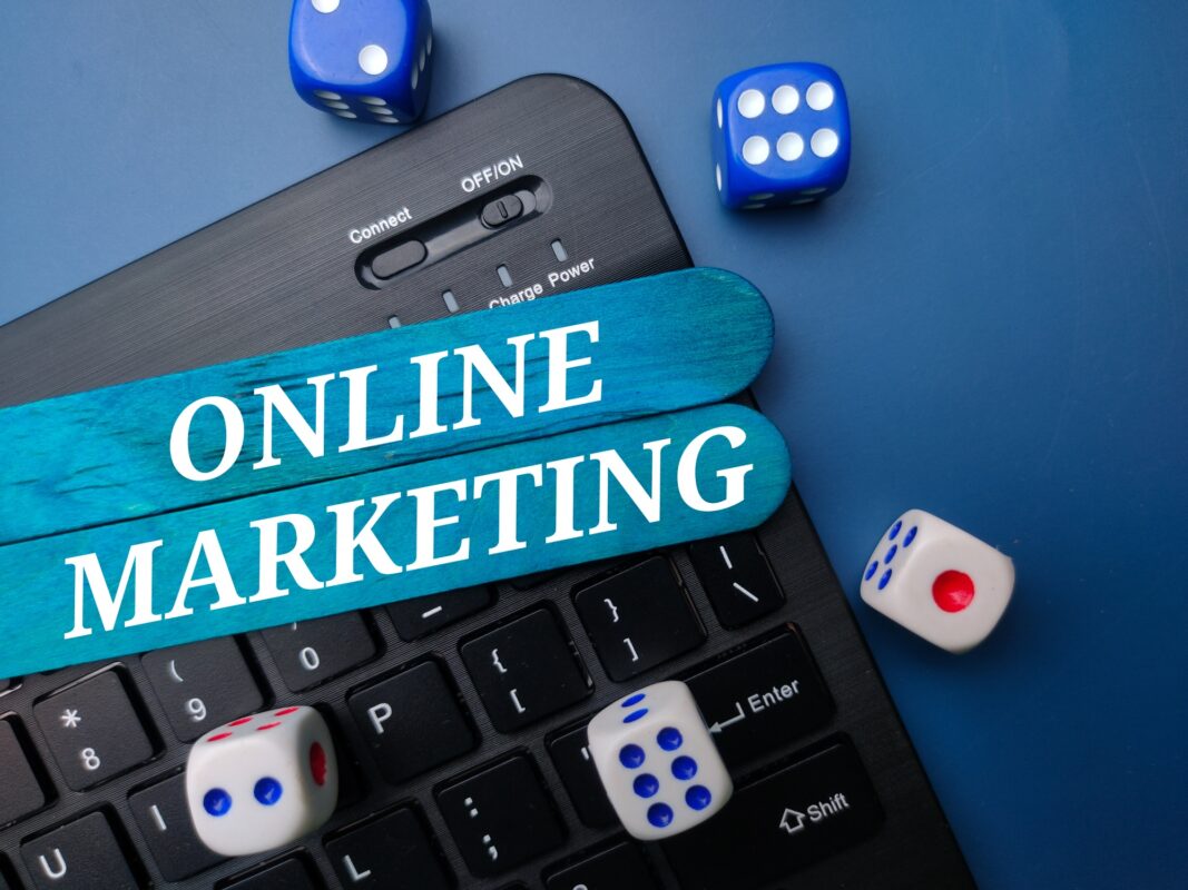 Keyboard and dice with the word ONLINE MARKETING. Business concept