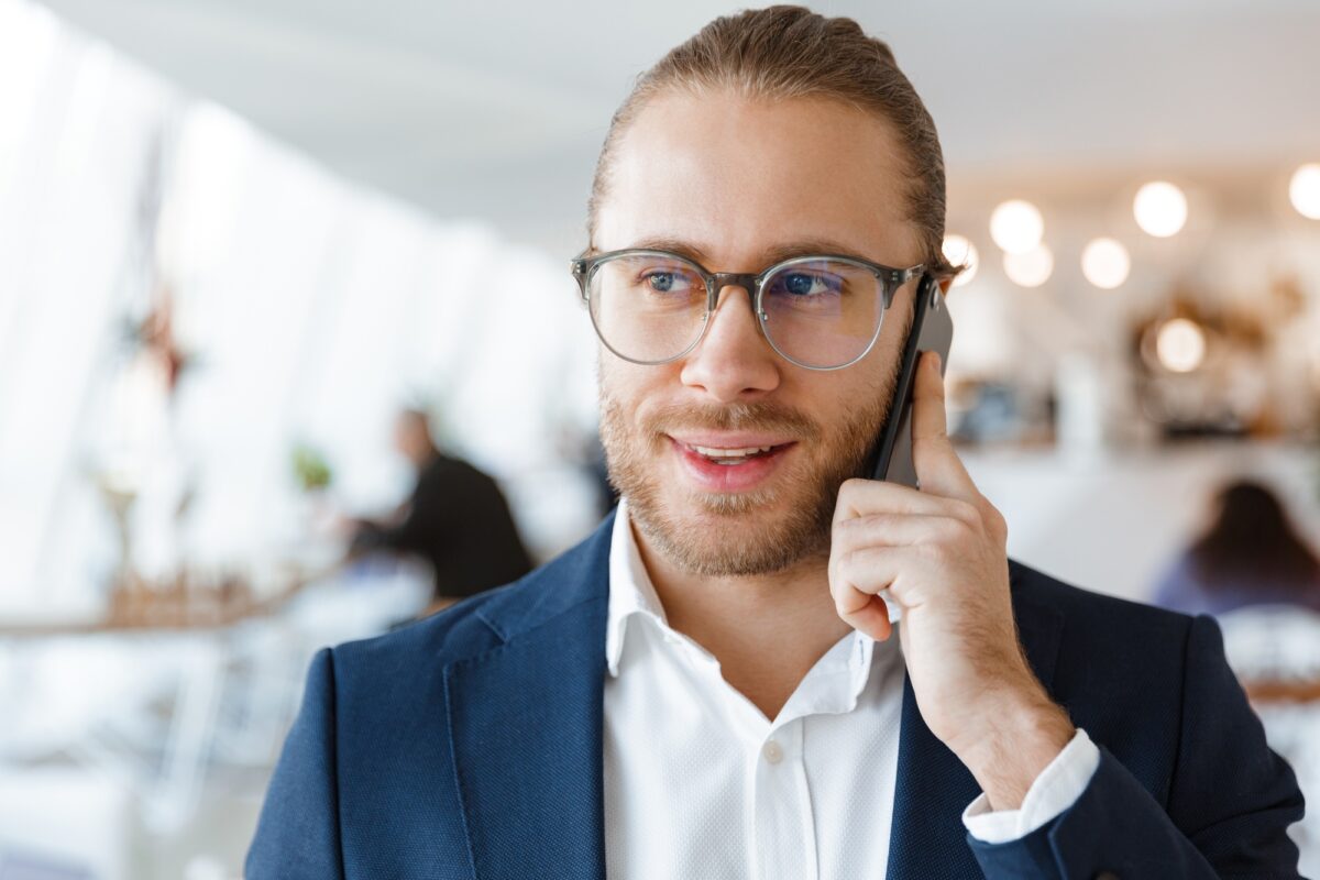 Pleased young businessman indoors in office